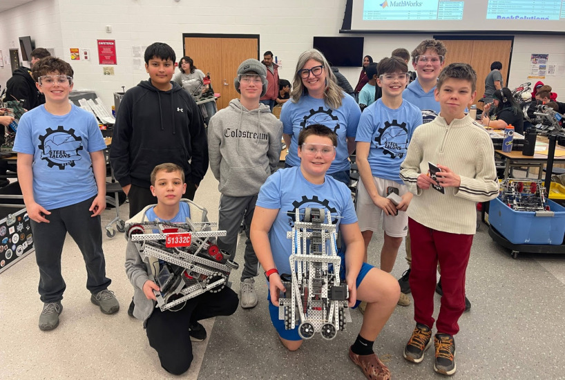 the nagel robotics team poses for a photo with their bots